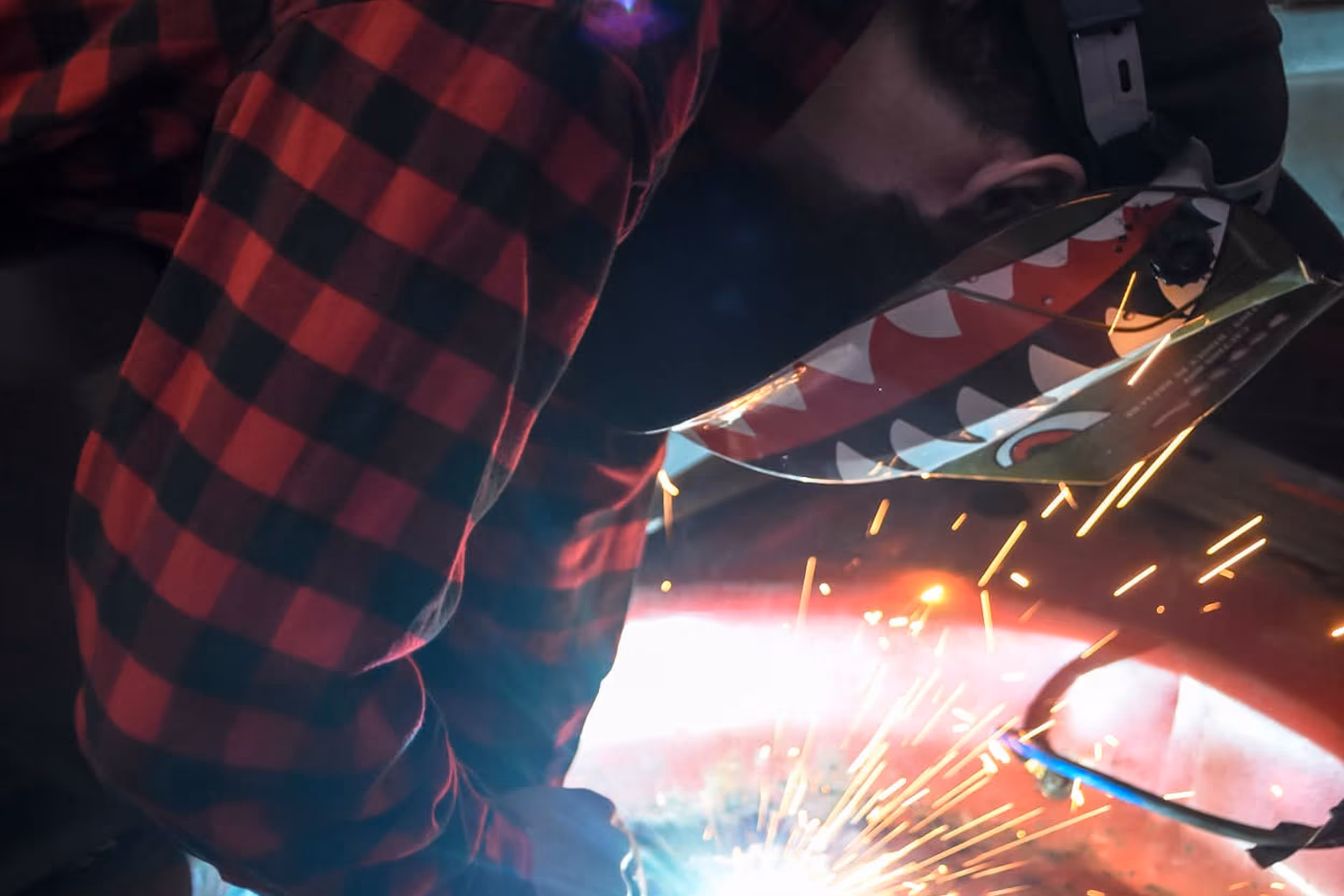 Welder in action with sparks flying