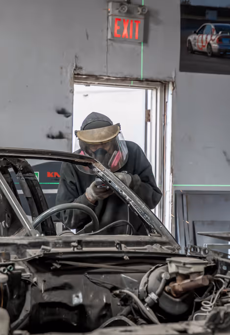 A rusted body section marked and prepped before cutting and welding.
