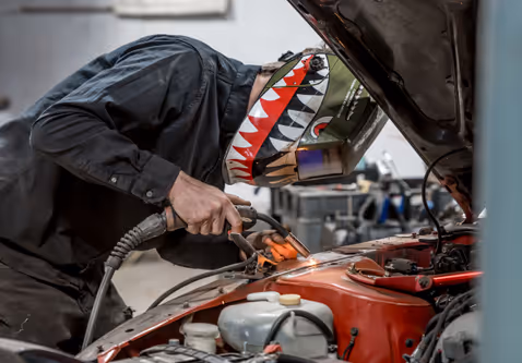 Dan lining up a weld on a custom metal fabrication piece.