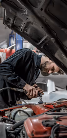 Dan brushing down car body during fabrication