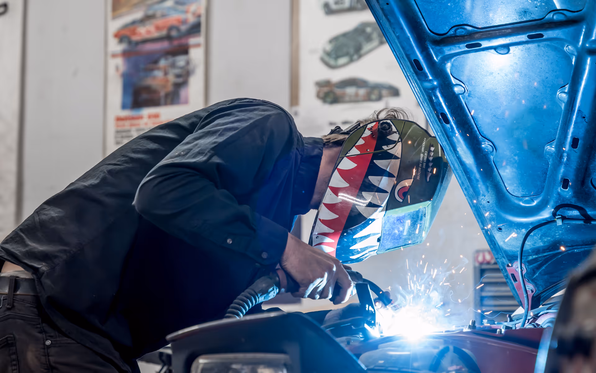 Dan mid-weld with sparks flying at DTM Fabrication