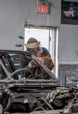 Mid-cut on car body panel with sparks during fabrication