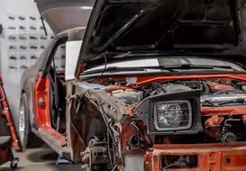 Red car quarter panel disassembled for custom fabrication work